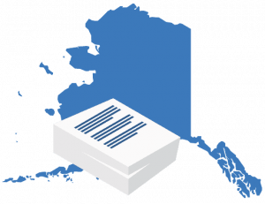 A large blue map of Alaska positioned behind a stack of white business documents.