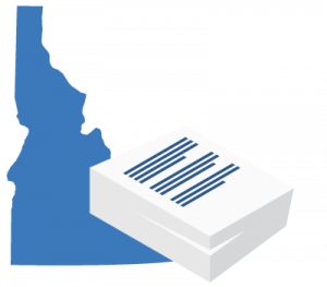 A large blue map of Alabama positioned behind a stack of white business documents