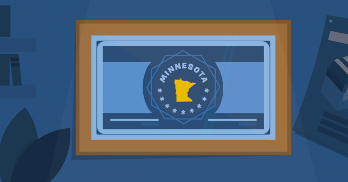 A plaque on a blue wall showing a badge reading "Minnesota" with an image of the state below.