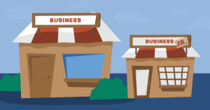 Store fronts next to each other with red and white striped roofs with larger storefront having a sign on the roof "Business" and the smaller storefront having a sign "Business Jr."